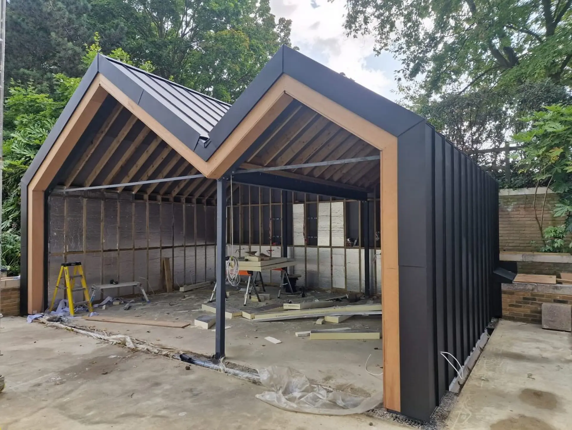 Modern aluminium garden room with Prefa aluminum black-grey cladding, London