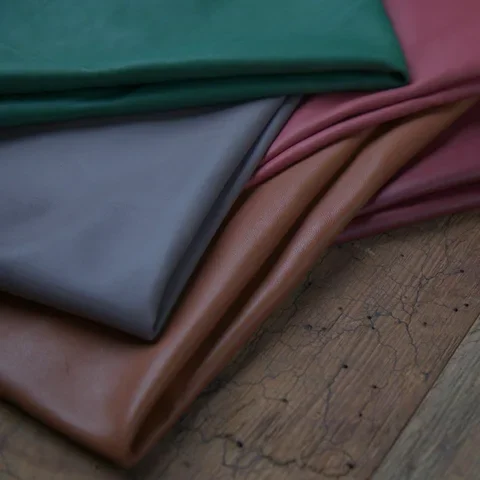 Folded leather hides in green, grey, red and tan