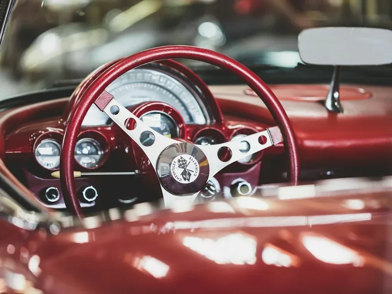 Red steering wheel and dashboard of a classic car