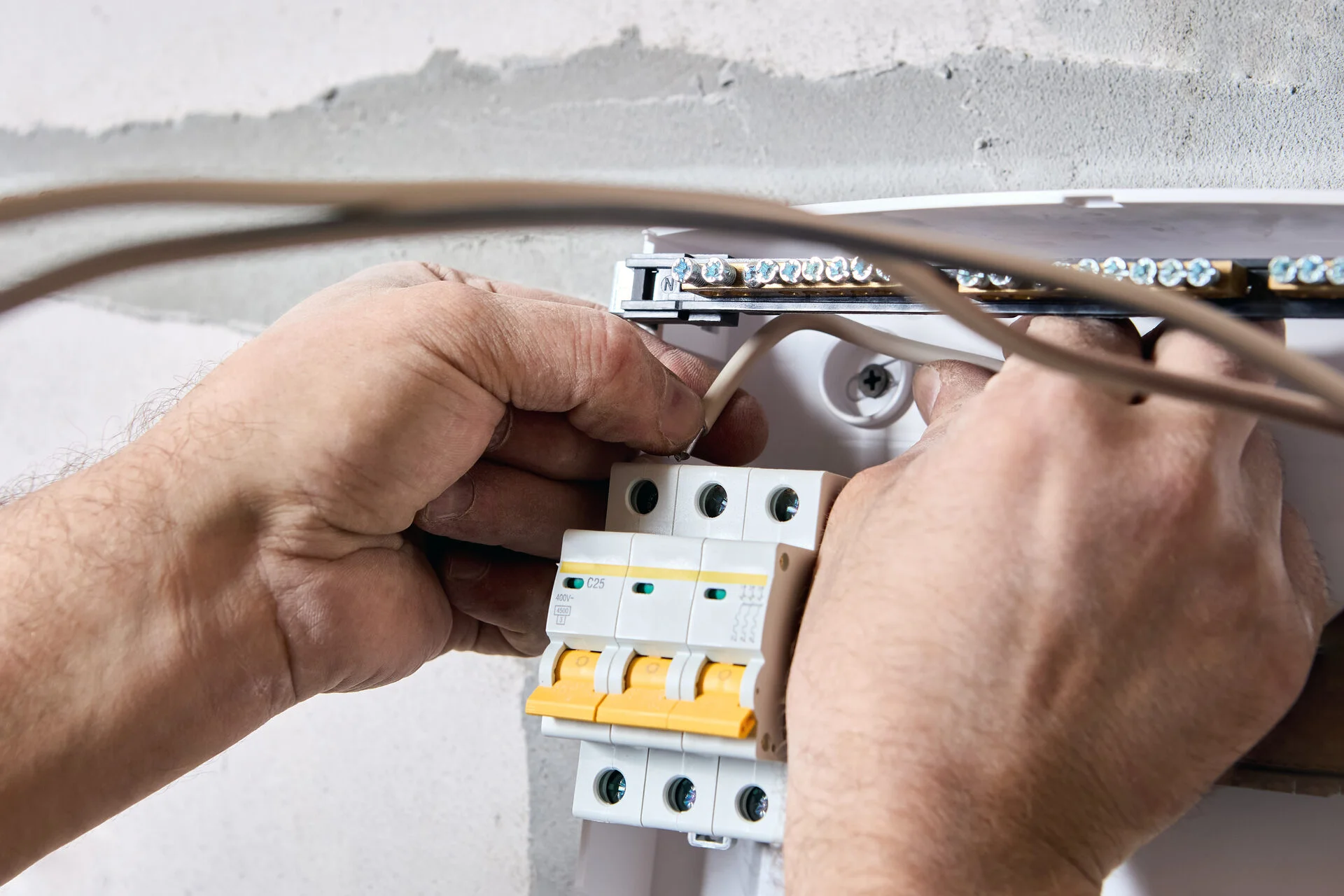 Electrician fitting a new consumer unit in Bristol