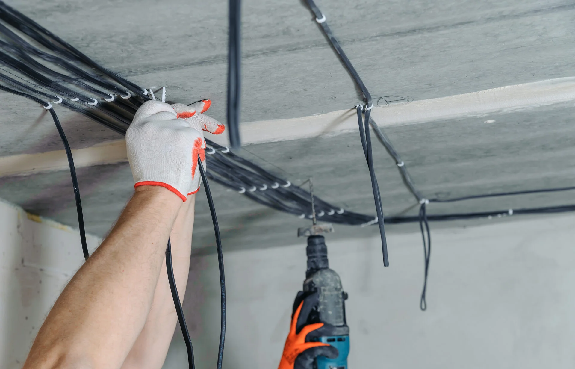 Electrician running new cables during a house rewire in Clifton