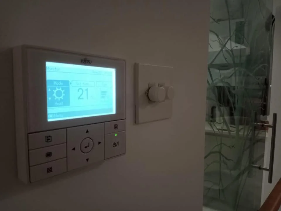 Air conditioning wall controller showing 21 degrees