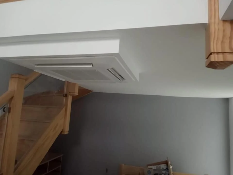 Two air conditioning outdoor units on a bungalow wall