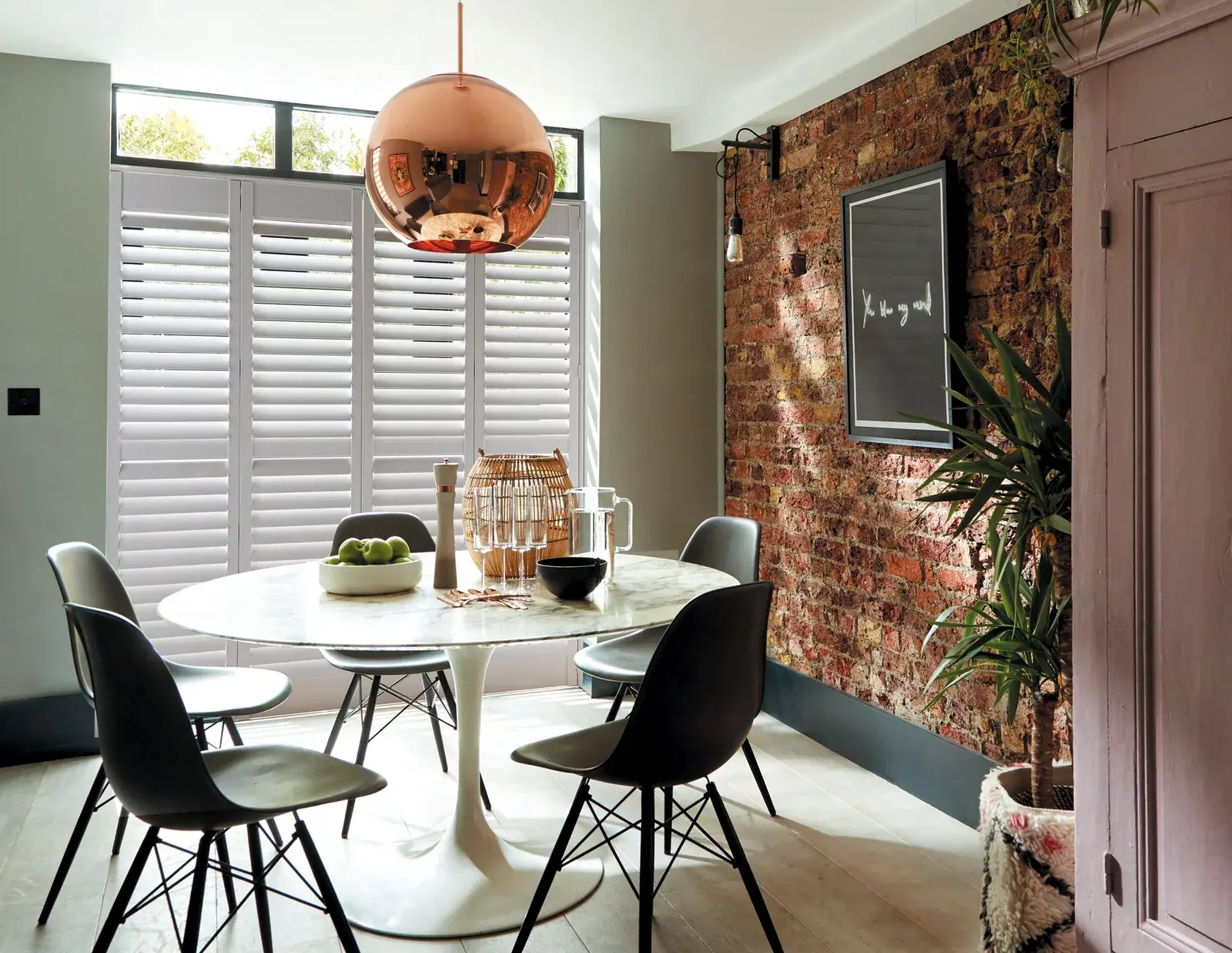 Caf&eacute; style plantation shutters on a street-facing window in a Chepstow dining room