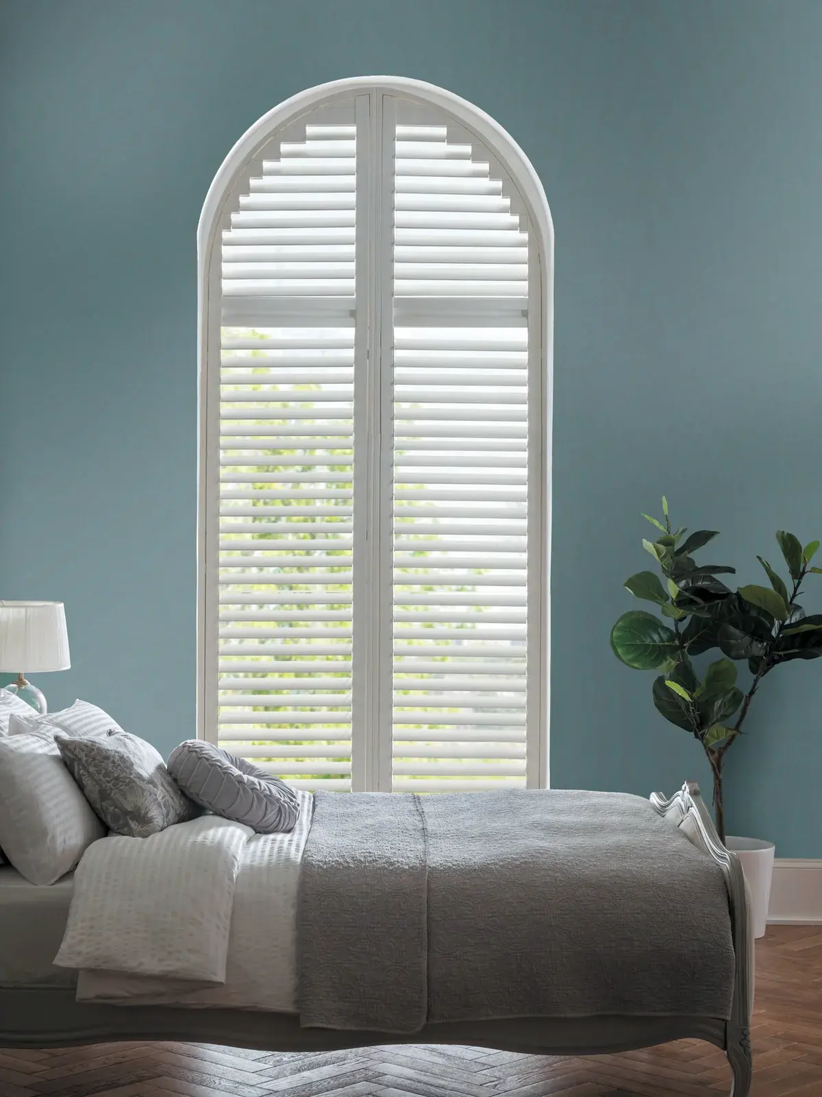 Shaped arched plantation shutters made to measure for a Chepstow feature window