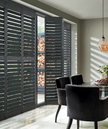 Tracked plantation shutters fitted across a wide opening in a Chepstow home