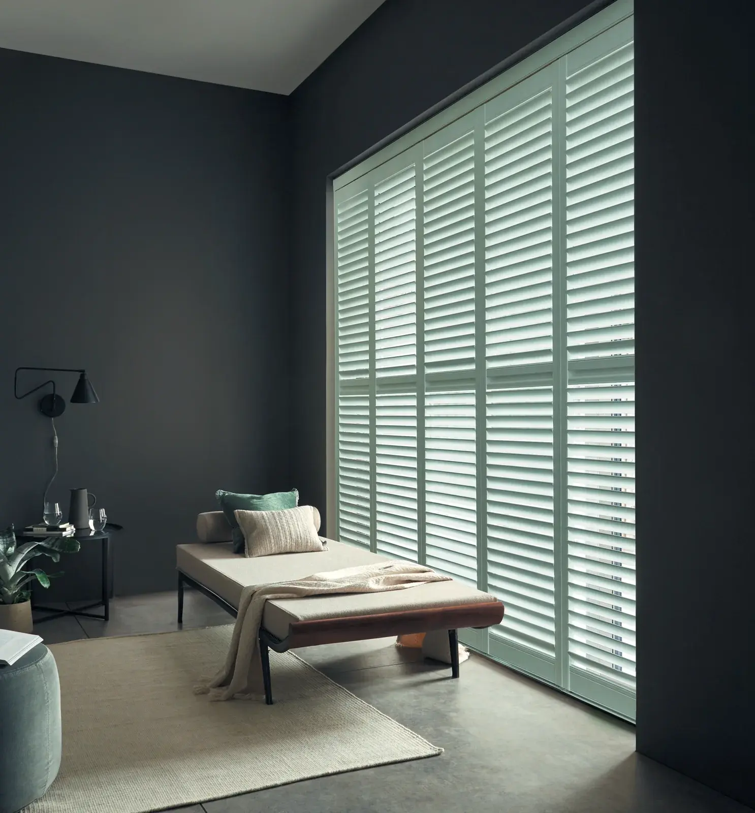 Green full height plantation shutters fitted in a Chepstow front-facing lounge