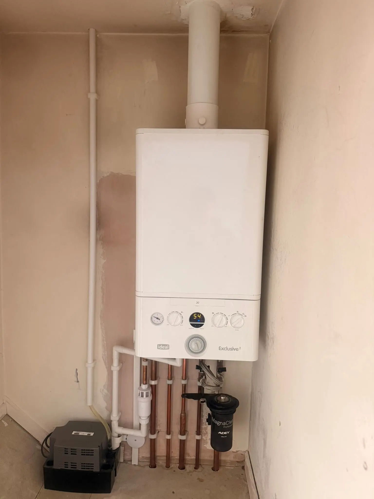 White Ideal boiler with visible pipework and magnetic filter