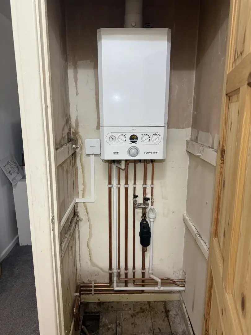 Wall-mounted boiler with neatly installed copper pipework