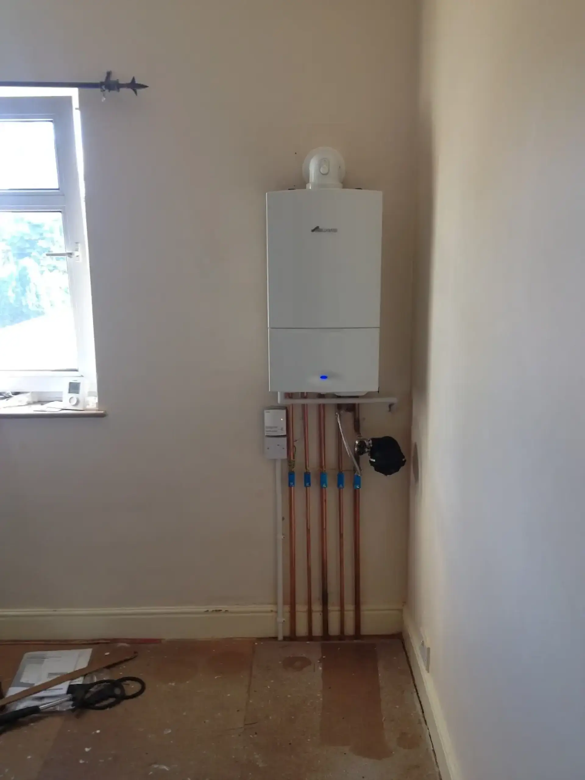 White boiler installed with neat copper pipework
