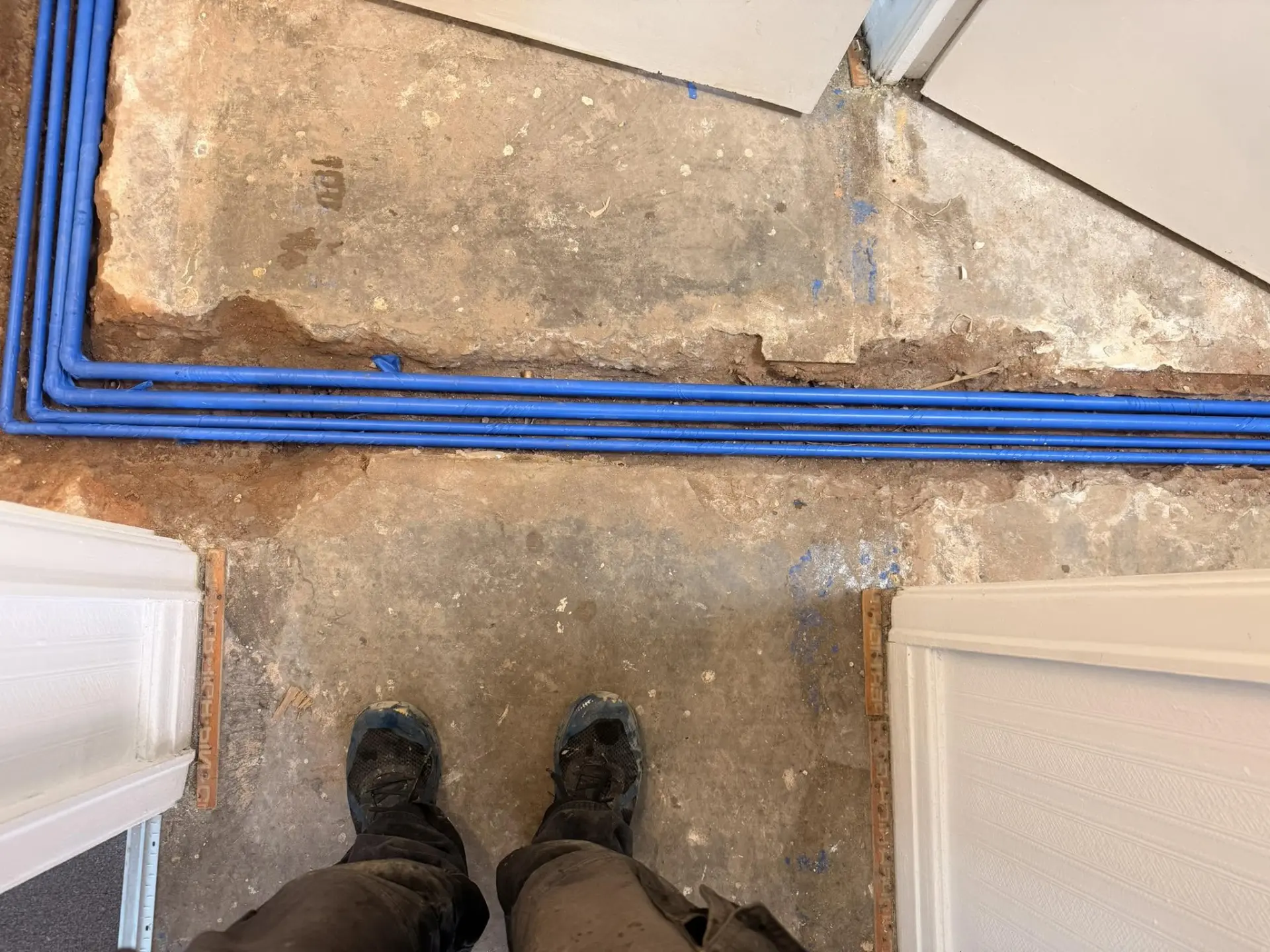Underfloor heating pipework installed in a chased concrete floor