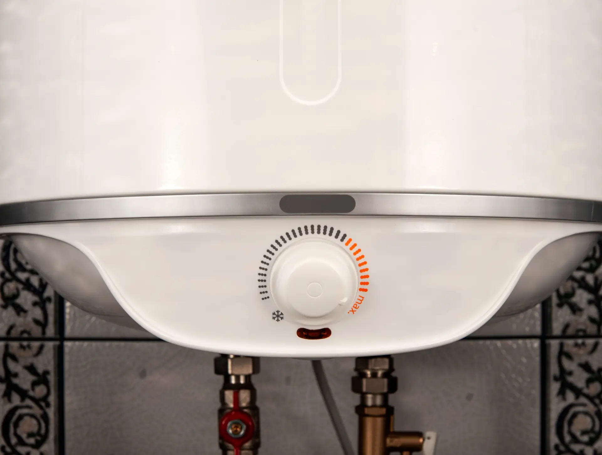 Close-up of a white boiler and its controls