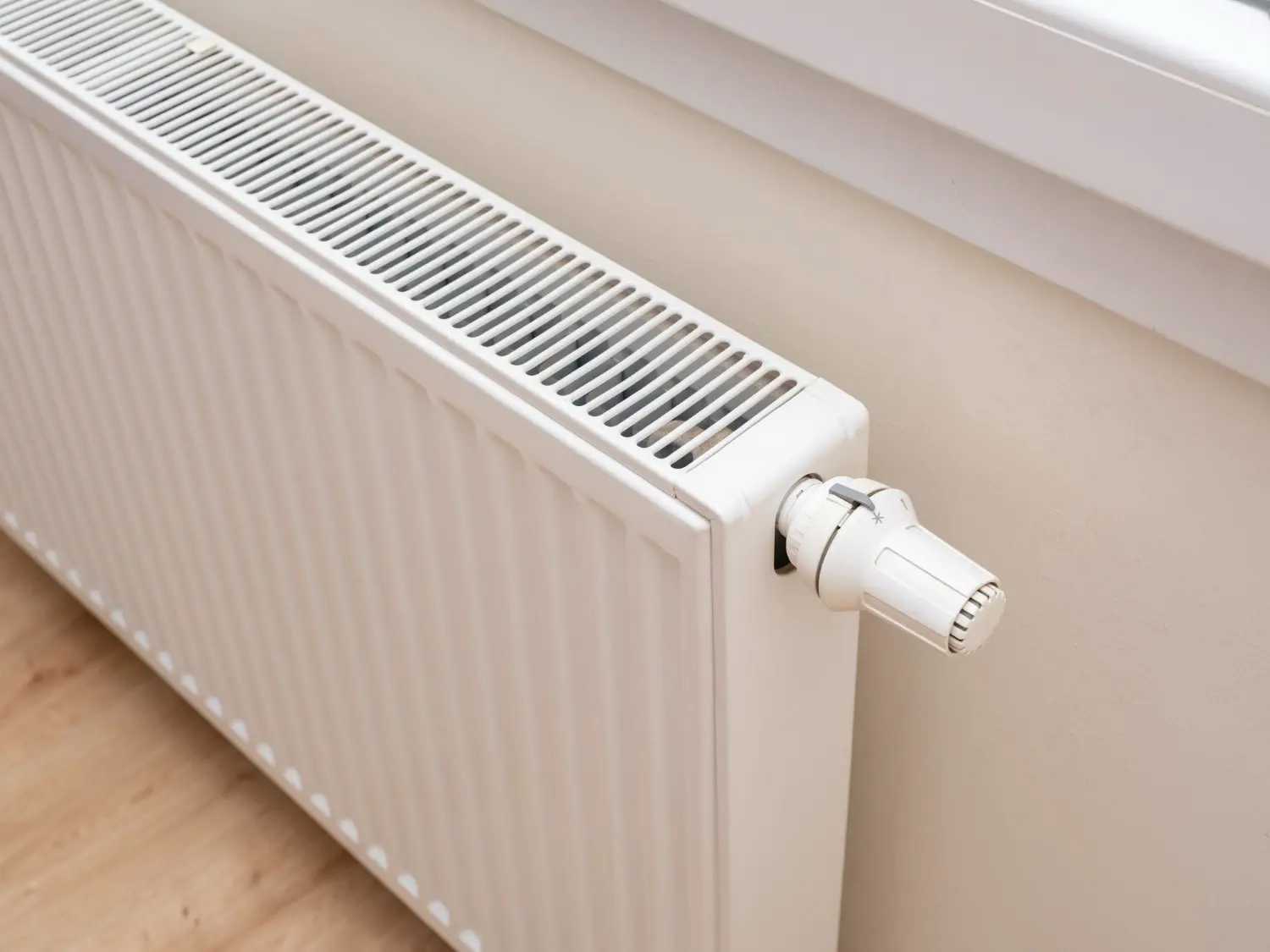 White panel radiator with thermostatic valve
