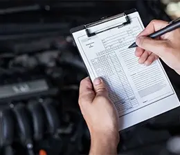 MOT Tests, Servicing & Repairs mechanic with a checklist
