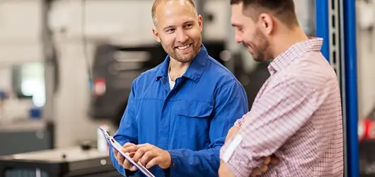 mechanic explaining mot report to customer