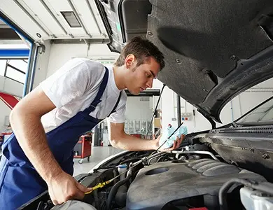 mechanic checking under car bonnet