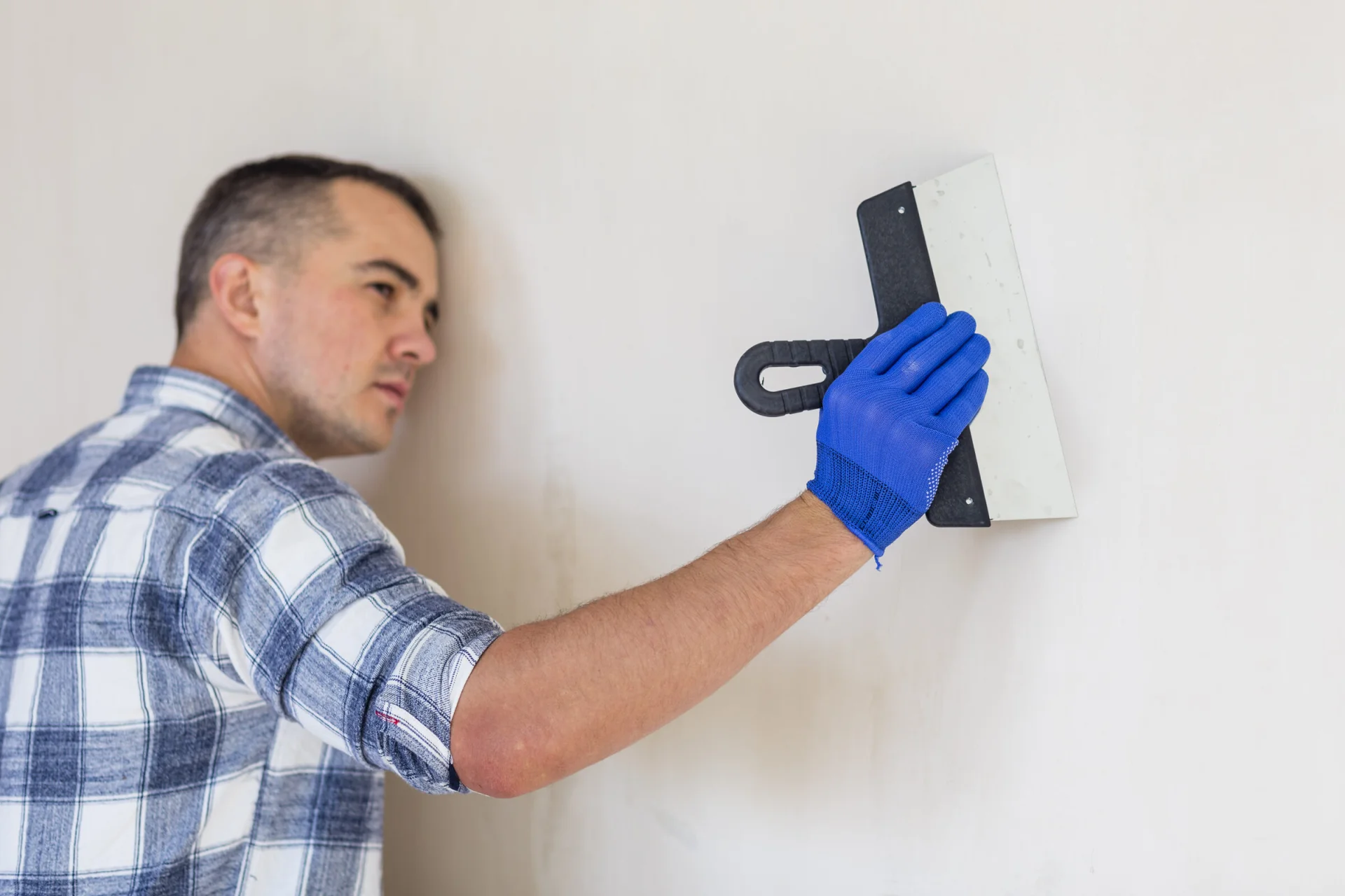 Plasterer smoothing a wall with a trowel