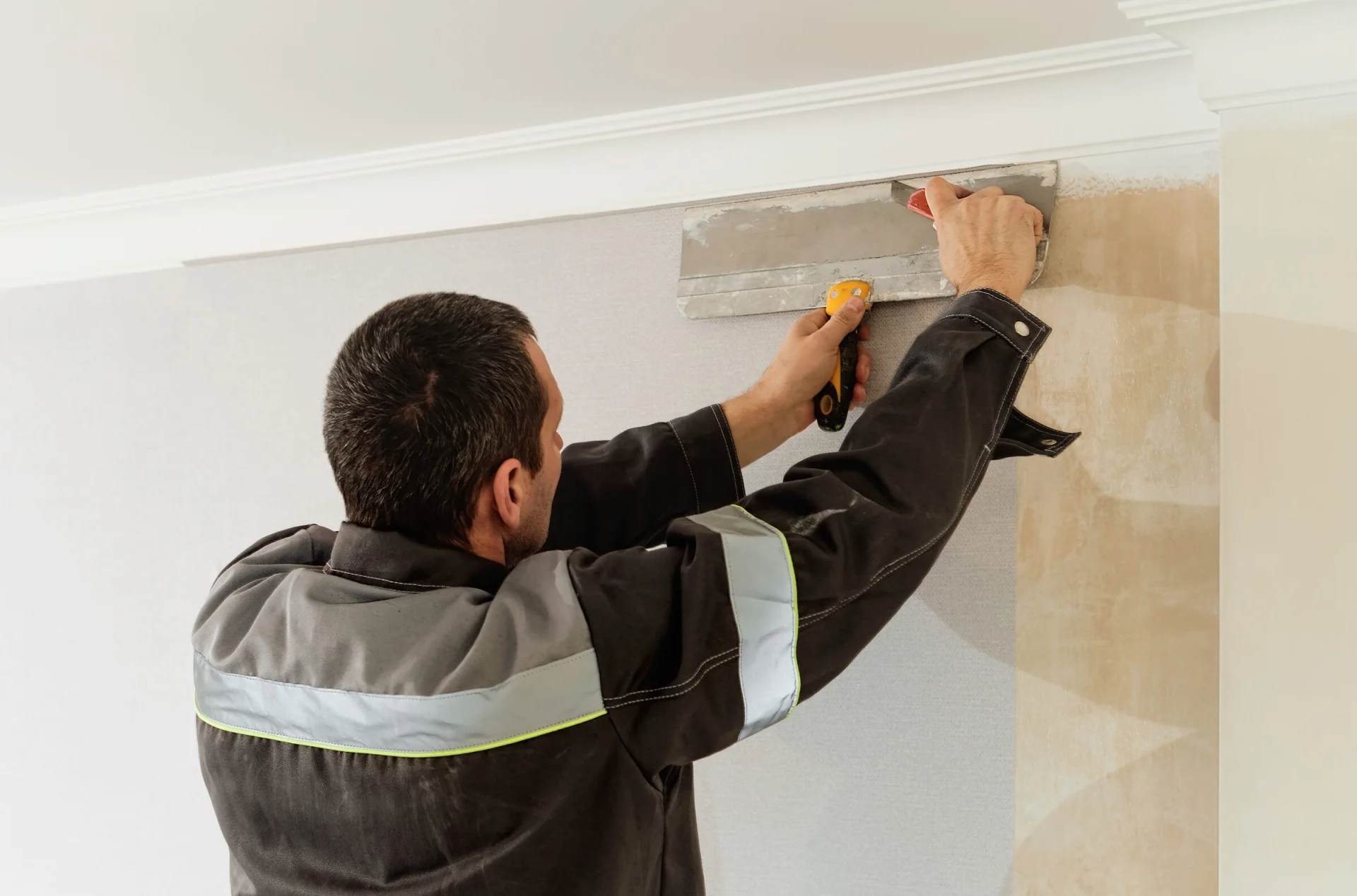 Tradesman preparing an interior wall